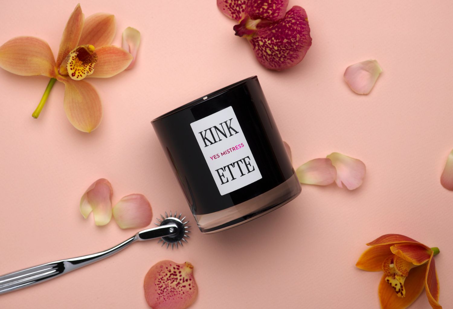 Black candle against a background of orange and red flowers