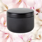 Travel candle against magnolia background