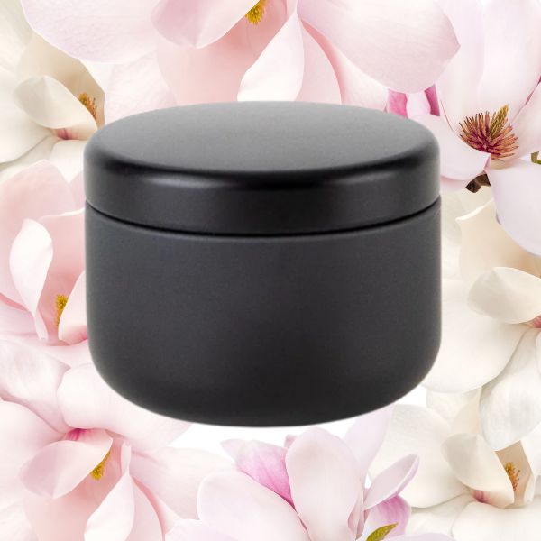 Travel candle against magnolia background