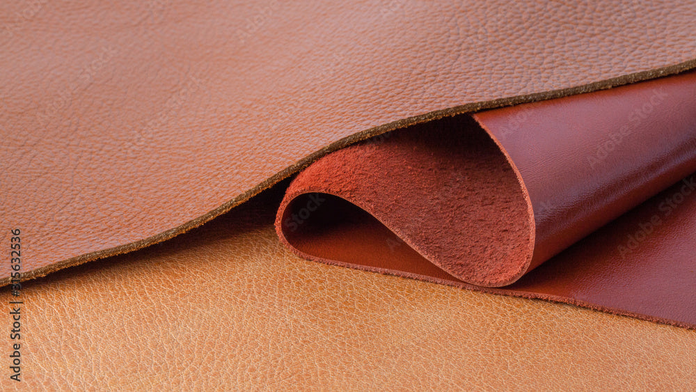 Close-up of tan leather and suede texture — crushed leather scent note in Kinkette DIRTY BOY luxury candle